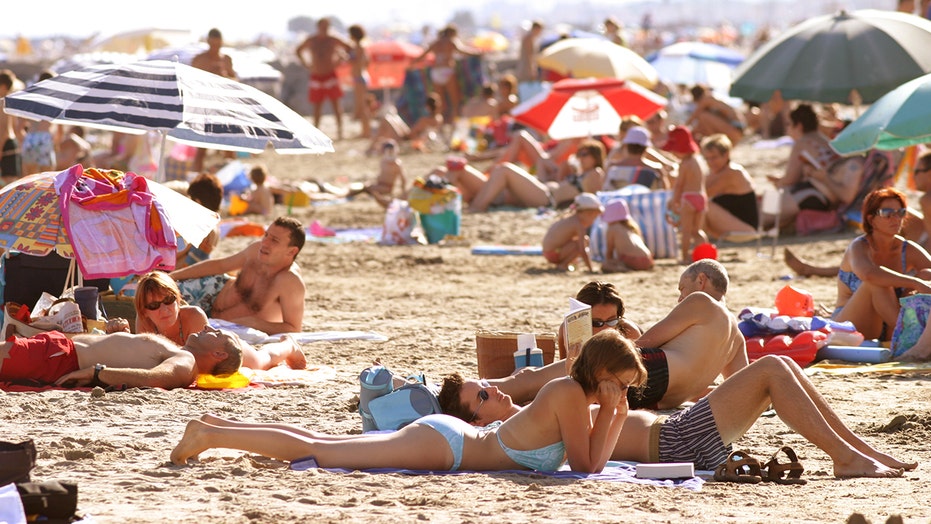 Nude women tanning on the beach